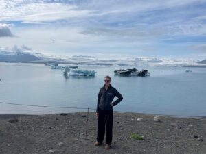 Woman standing at glacial tongue in Iceland.