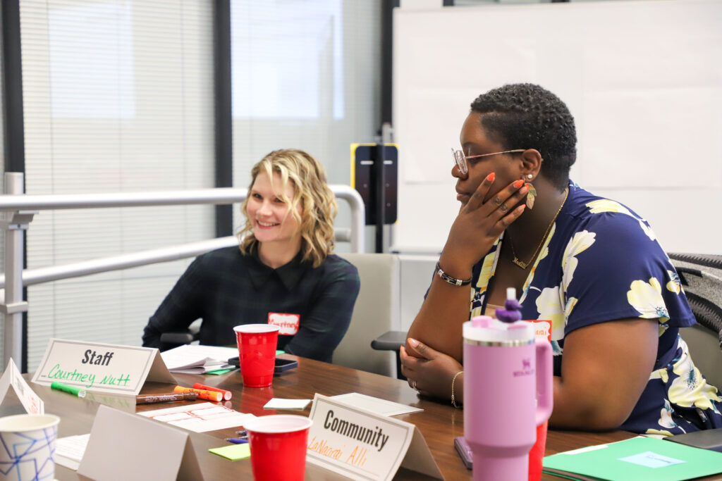 Two women engage in discussion.