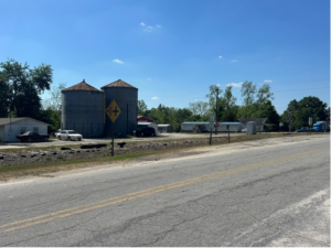 Road with two silos in the background.